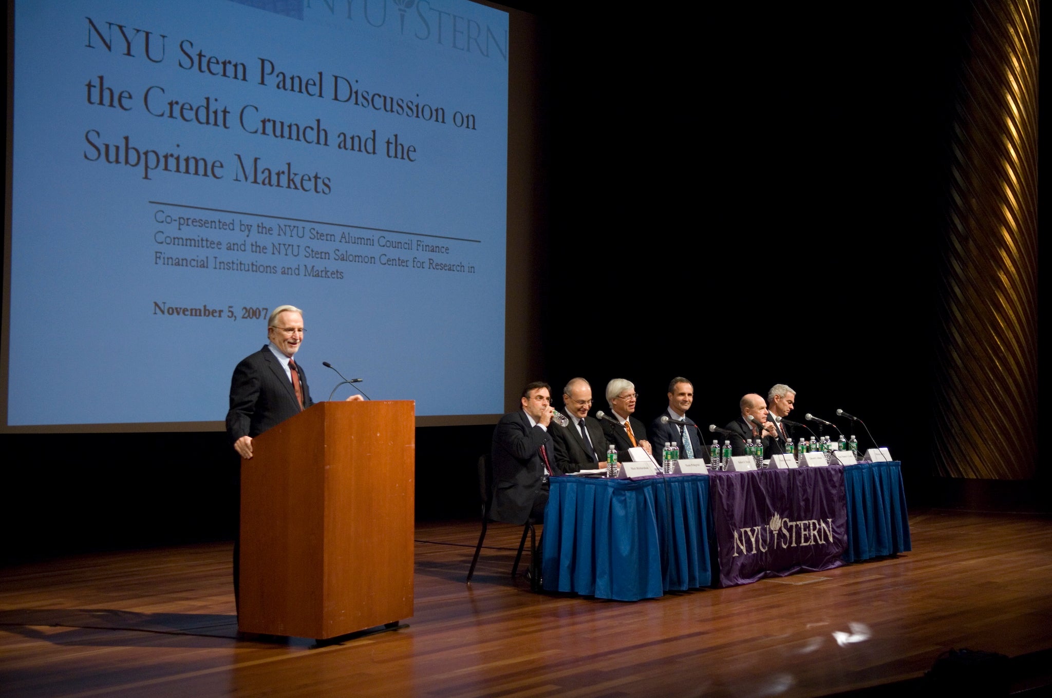 Thomas F. Cooley speaks at a lectern during a panel discussion Thomas F. Cooley speaks at a lectern during a panel discussion